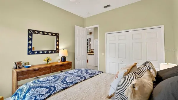 a living room with furniture a flat screen tv and a floor to ceiling window