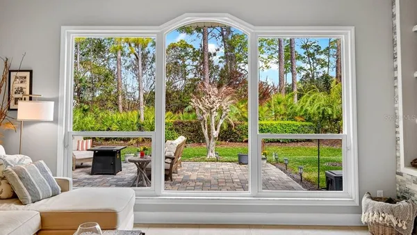 a living room with dining table a flat screen tv and kitchen view