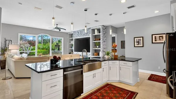an aerial view of residential houses with outdoor space and ocean view