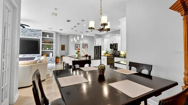 a view of a lake with couches in wooden deck and lake view