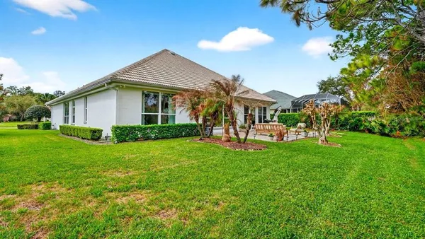 a view of a lake with a table and chairs