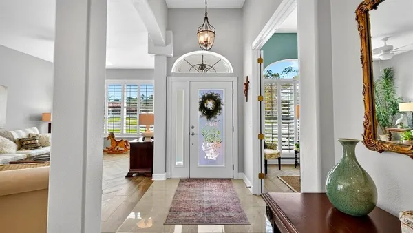 a living room with furniture and a chandelier