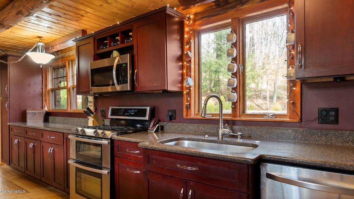 10 South Beech Plain Road Sandisfield, MA 01255 - Photo 13 of 48 a kitchen with stainless steel appliances granite countertop a sink a stove and a microwave