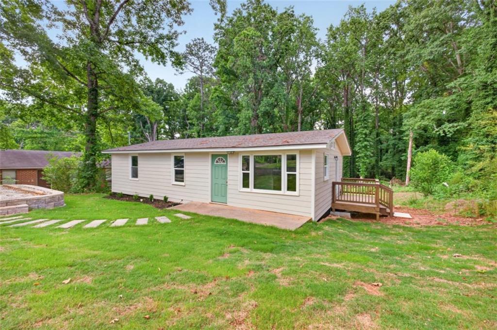 136 Nowell Street Monroe, GA 30655 - Photo 3 of 25 a view of a house with a backyard and a patio