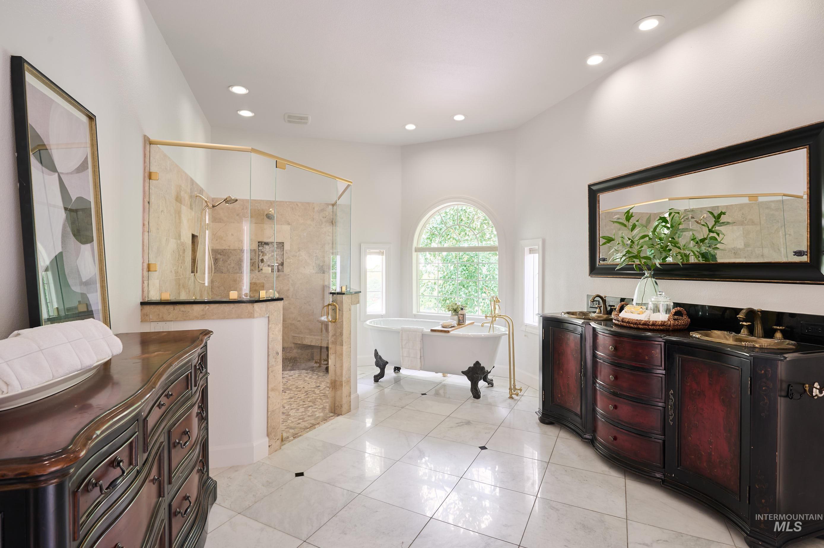 3931 North Triple Ridge Place Eagle, ID 83616 - Photo 14 of 45 Full bath with a soaking tub, a stall shower, vanity, light tile patterned floors, and recessed lighting
