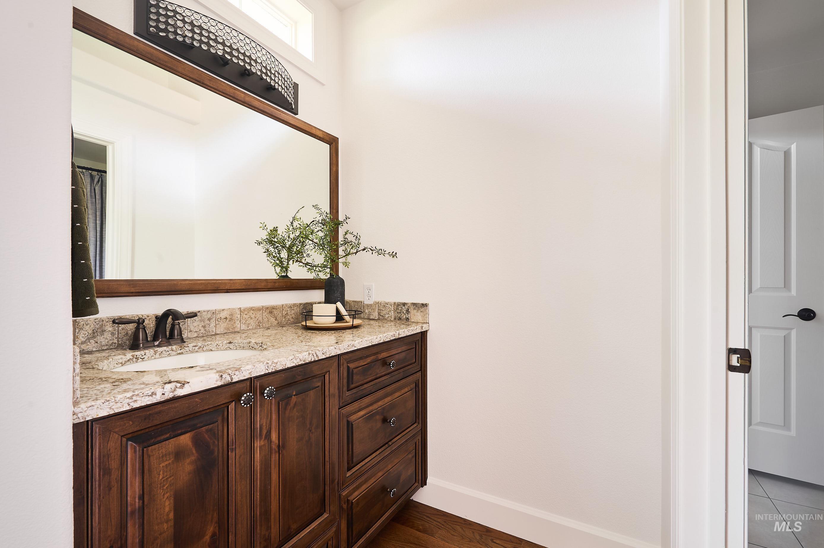 3931 North Triple Ridge Place Eagle, ID 83616 - Photo 17 of 45 Bathroom with vanity and baseboards