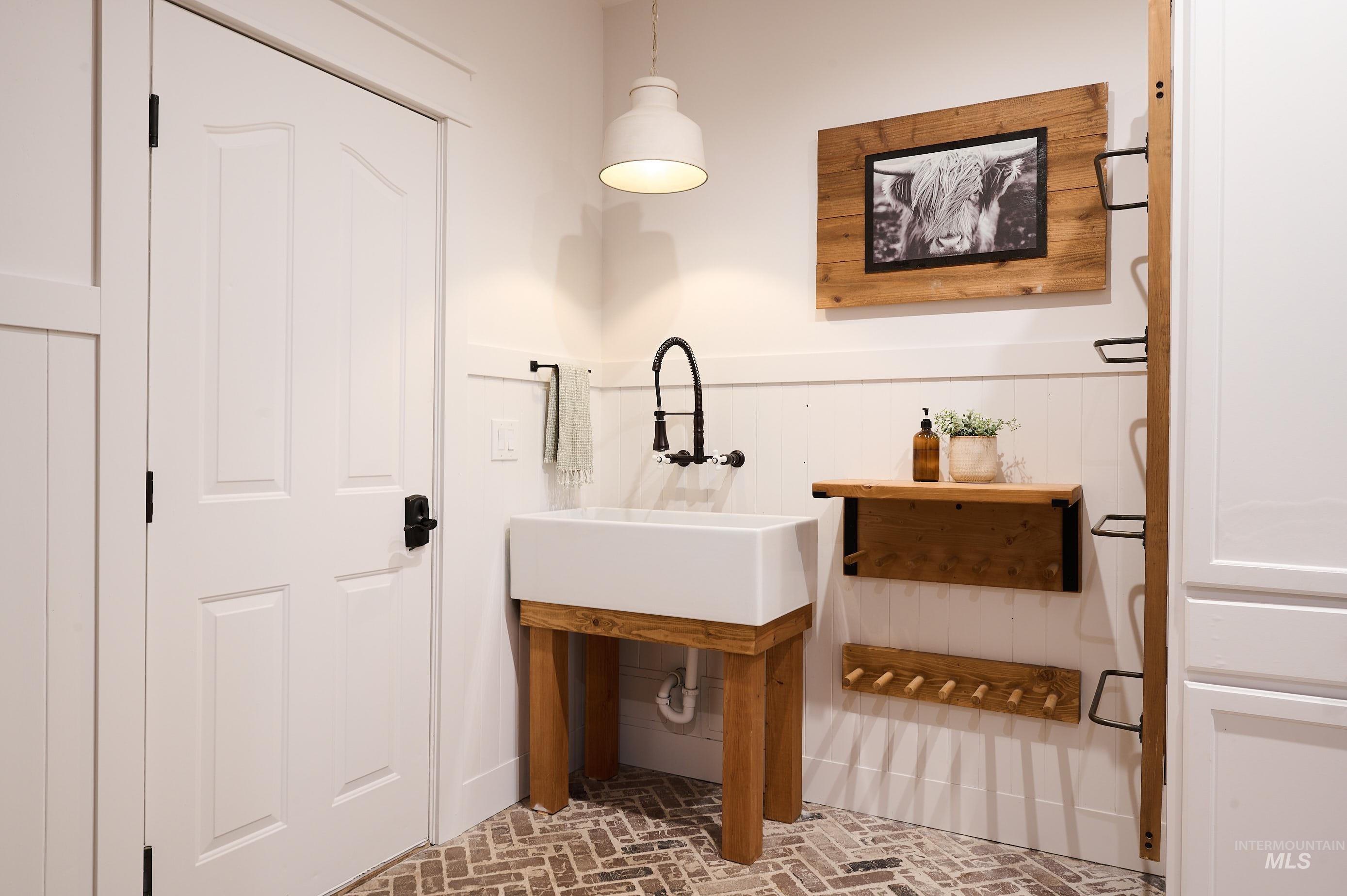 3931 North Triple Ridge Place Eagle, ID 83616 - Photo 28 of 45 Bathroom featuring brick flooring and a sink