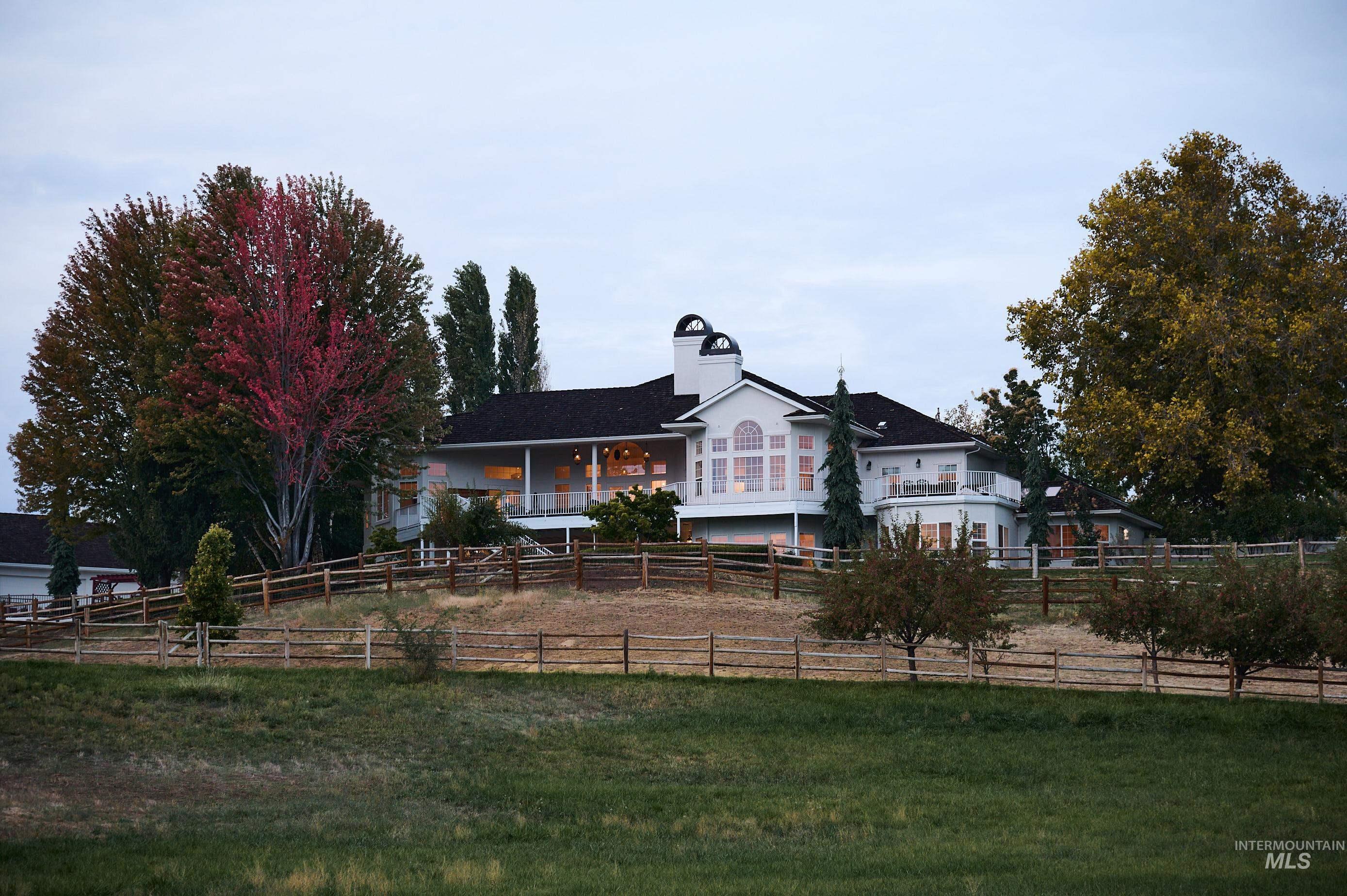 3931 North Triple Ridge Place Eagle, ID 83616 - Photo 29 of 45 View of front of house featuring a fenced backyard, a chimney, and a porch