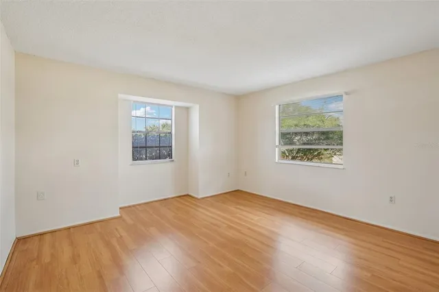 a view of empty room with wooden floor