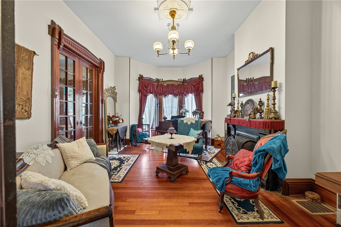51 Seneca Street Starkey, NY 14837 - Photo 9 of 41 pocket doors in front parlor with fireplace