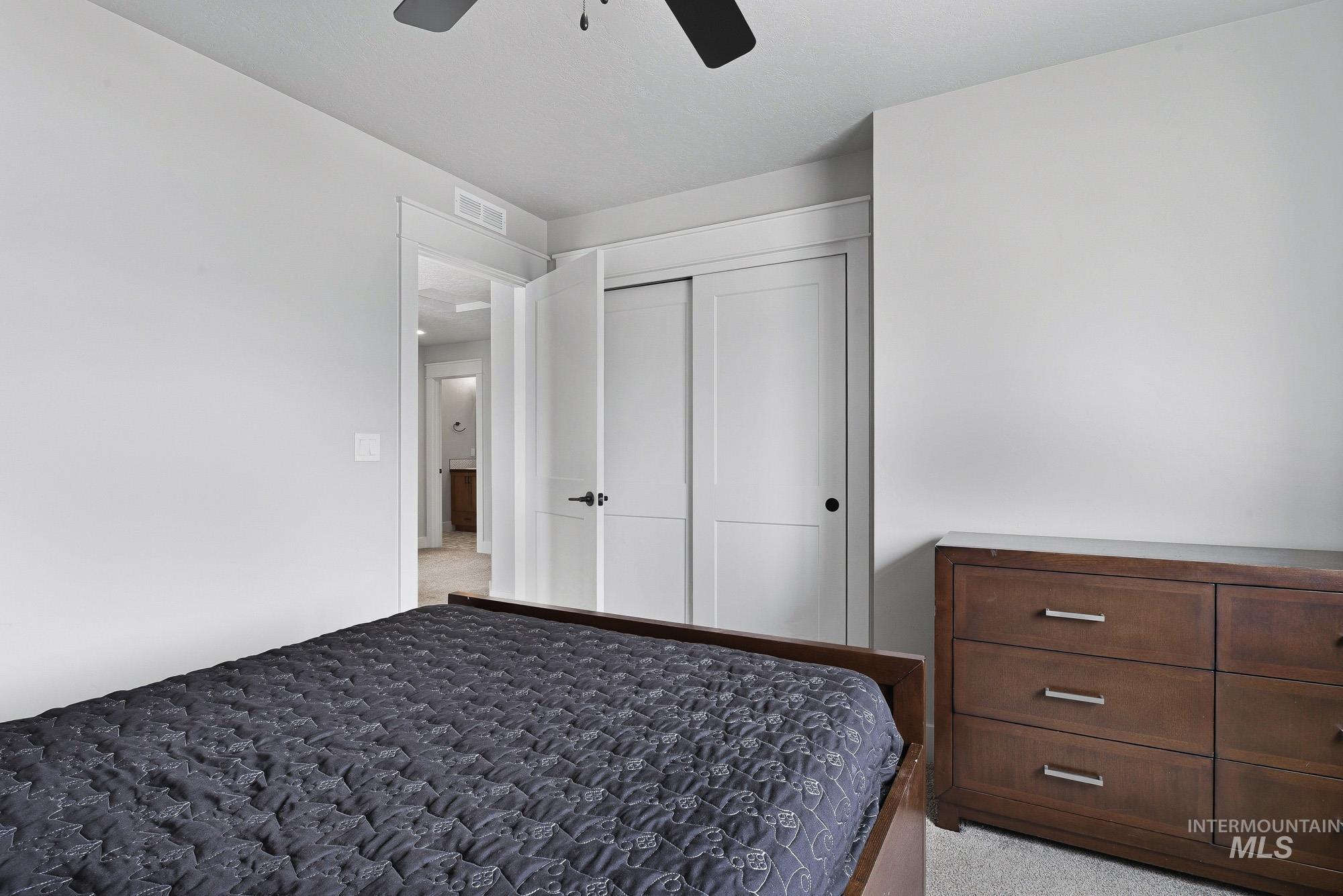 5676 East Zaffre Ridge Street Boise, ID 83716 - Photo 40 of 50 Bedroom featuring light gray wall paint, a ceiling fan, and carpet flooring