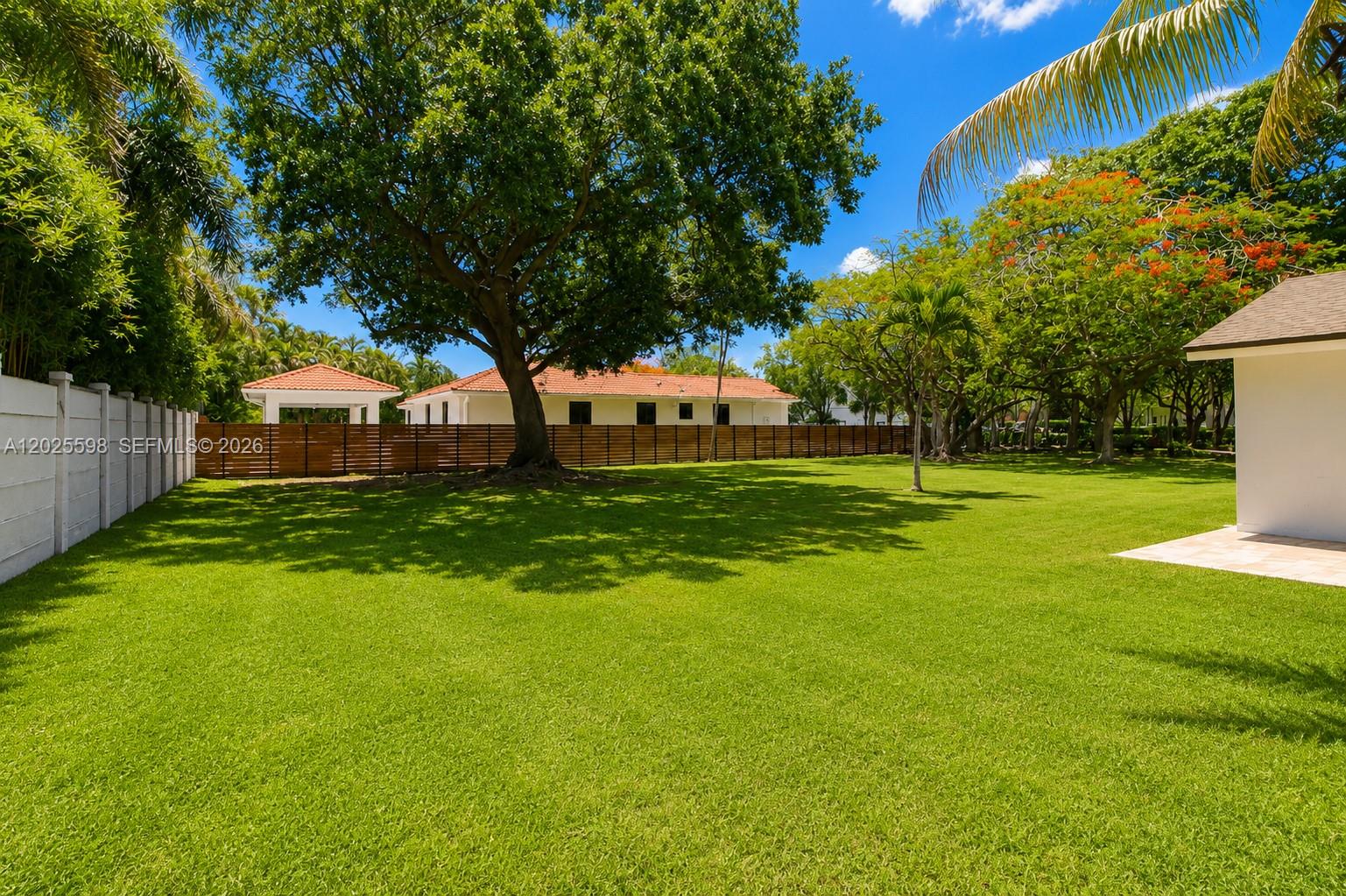 9421 Southwest 150th Street Miami, FL 33176 - Photo 26 of 31 a view of a house with a big yard