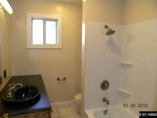 8585 Aquifer Way Reno, NV 89506 - Photo 8 of 12 a bathroom with a sink toilet and shower