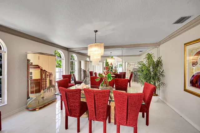 a dining room with furniture a rug and a chandelier