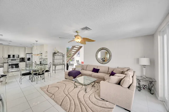 a kitchen with stainless steel appliances kitchen island granite countertop a stove a sink and a refrigerator