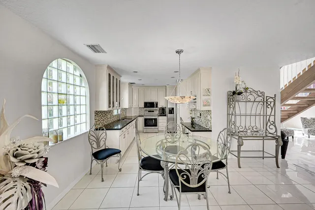 a kitchen with granite countertop a sink stainless steel appliances and cabinets