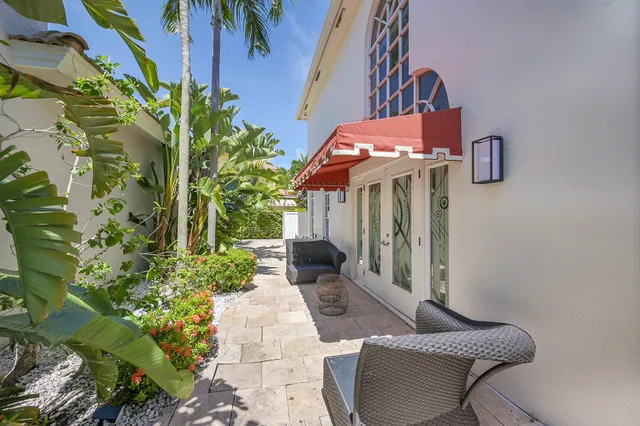 a backyard of a house with yard and outdoor seating