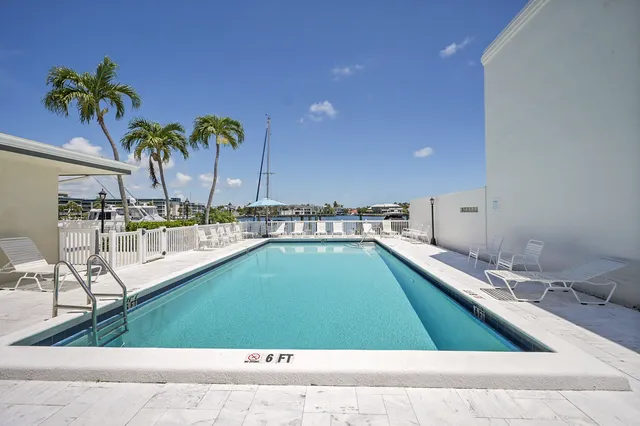an aerial view of a house with outdoor space and lake view in back