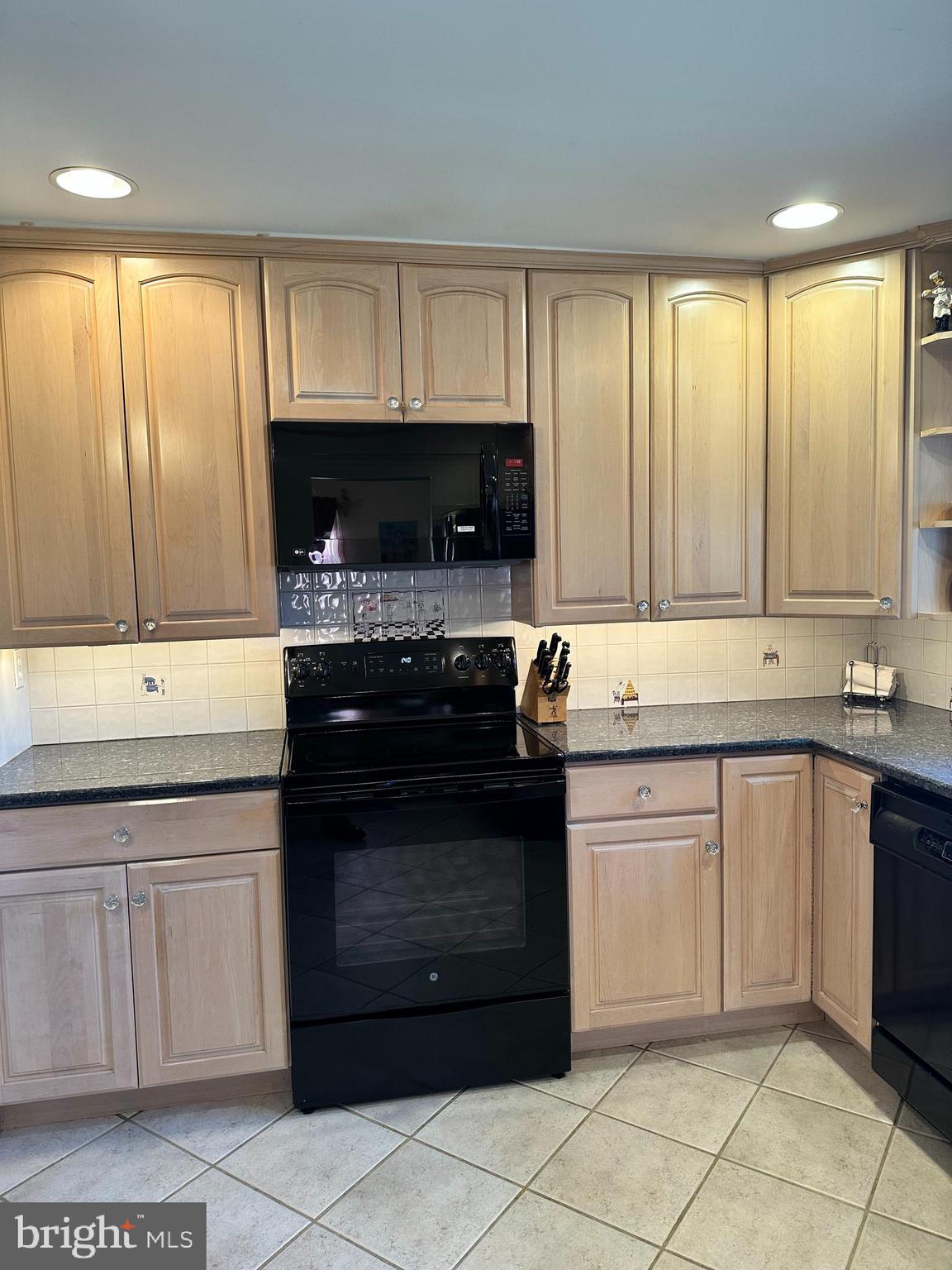 118 Spring House Road Cherry Hill, NJ 08002 - Photo 5 of 19 a kitchen with granite countertop a stove top oven microwave and cabinets