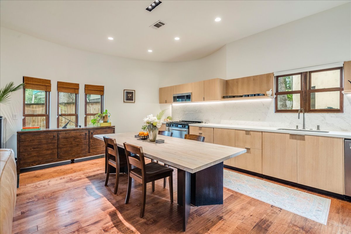 3012 South 4th Street, Unit B Austin, TX 78704 - Photo 10 of 40 Open-concept kitchen and dining area featuring wood-finish flooring, recessed lighting, and a vaulted ceiling