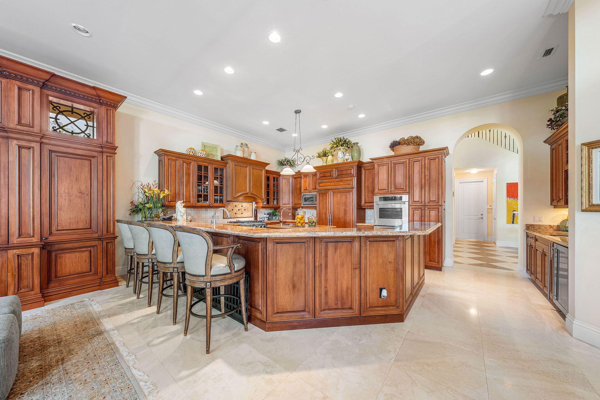 2386 West Maya Palm Drive Boca Raton, FL 33432 - Photo 20 of 76 a kitchen with stainless steel appliances kitchen island granite countertop a table and chairs in it