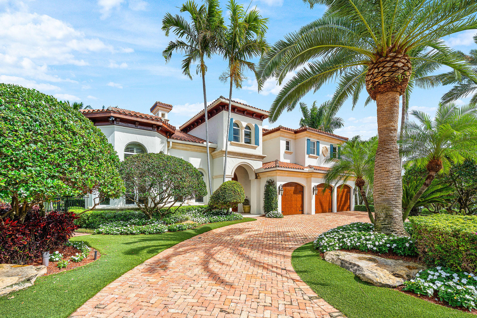 2386 West Maya Palm Drive Boca Raton, FL 33432 - Photo 2 of 76 a front view of a house with a garden