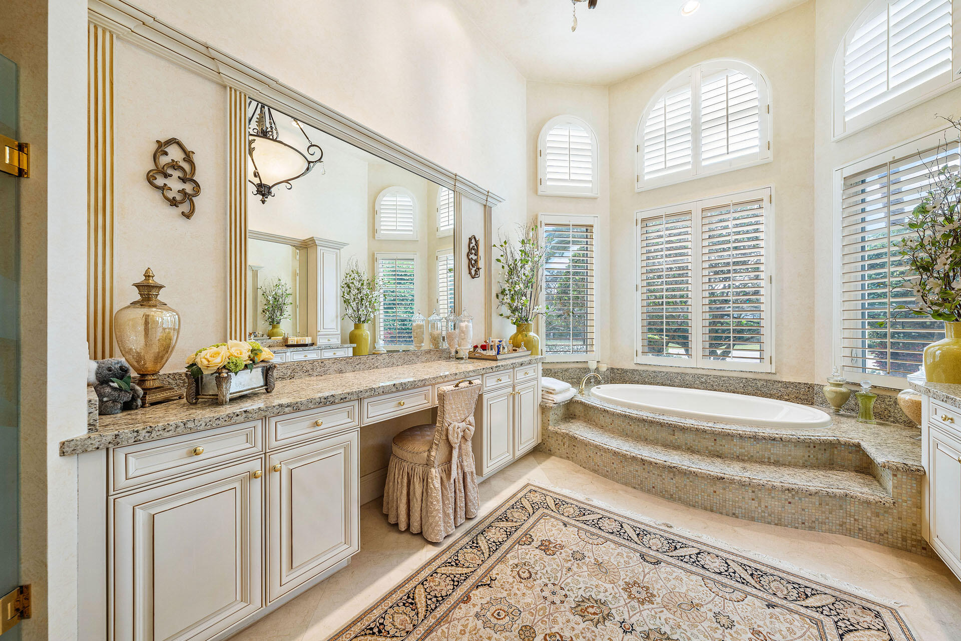 2386 West Maya Palm Drive Boca Raton, FL 33432 - Photo 40 of 76 a spacious bathroom with a granite countertop sink and a large mirror next to a window
