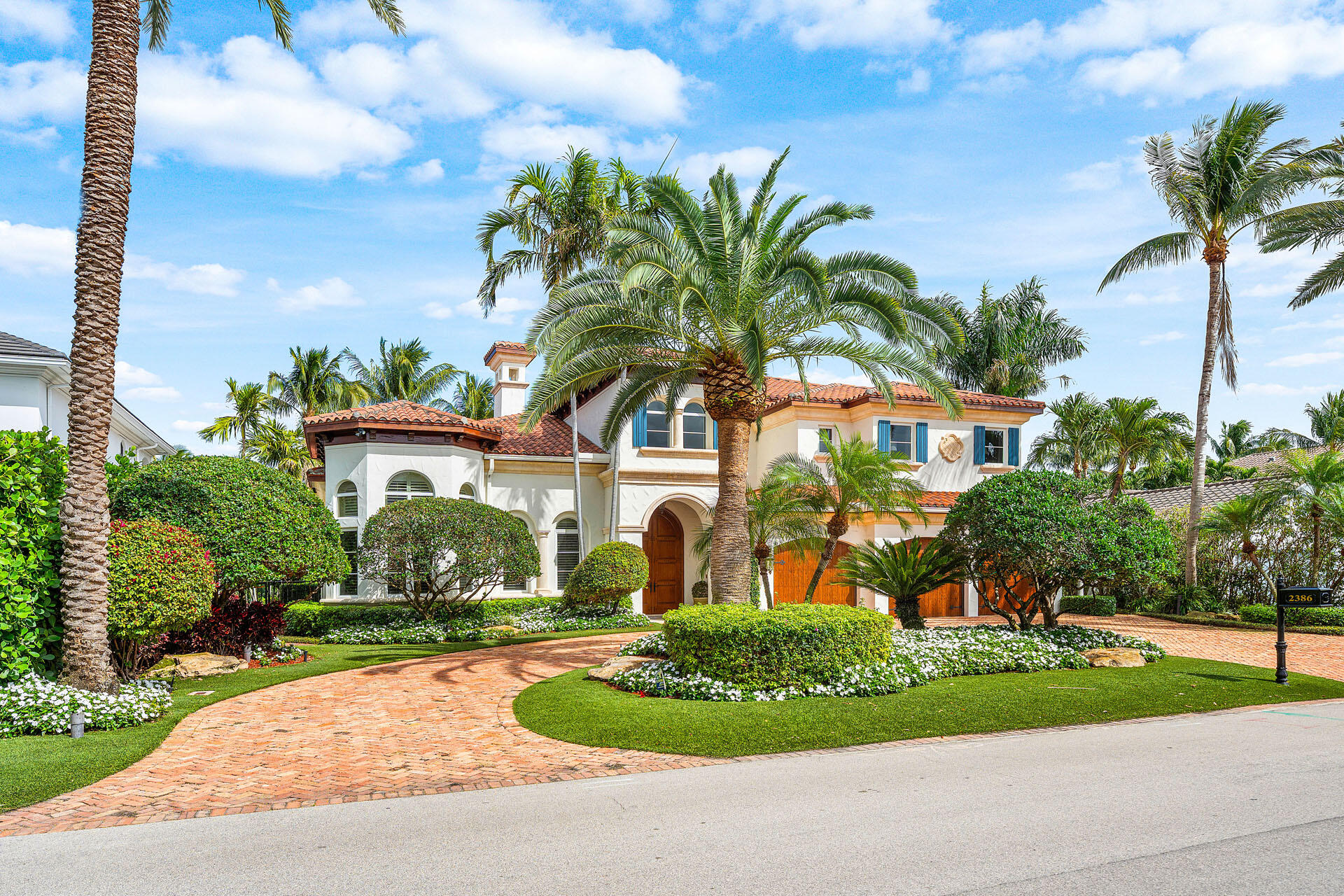 2386 West Maya Palm Drive Boca Raton, FL 33432 - Photo 4 of 76 a front view of a house with garden and trees