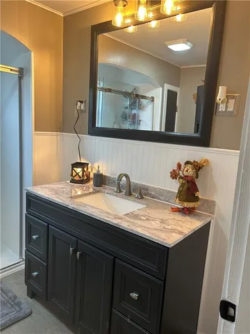 a bathroom with a granite countertop sink a toilet a shower and a mirror
