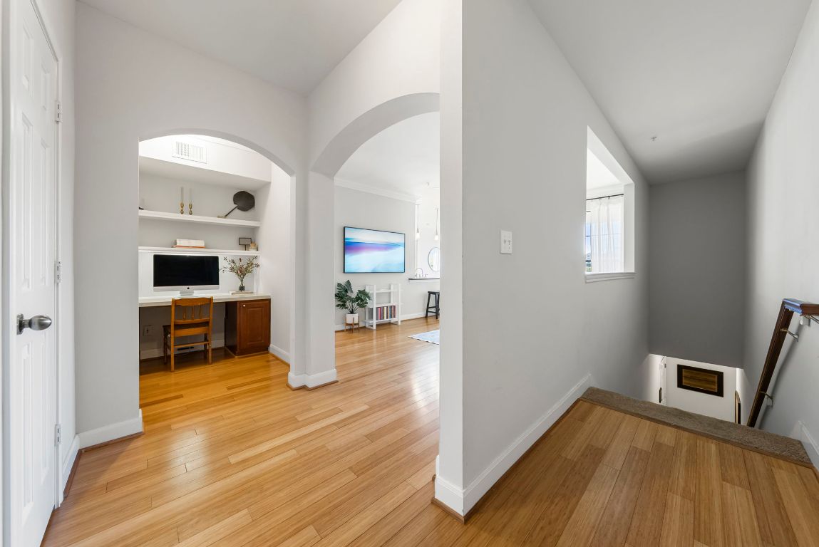 7701 Rialto Boulevard, Unit 1426 Austin, TX 78735 - Photo 17 of 29 a room with wooden floor and a fireplace