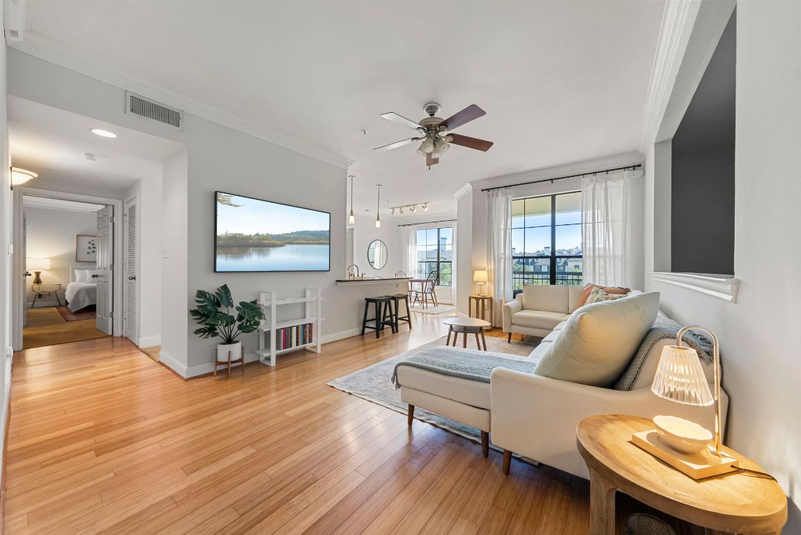 7701 Rialto Boulevard, Unit 1426 Austin, TX 78735 - Photo 2 of 29 a living room with furniture and a wooden floor
