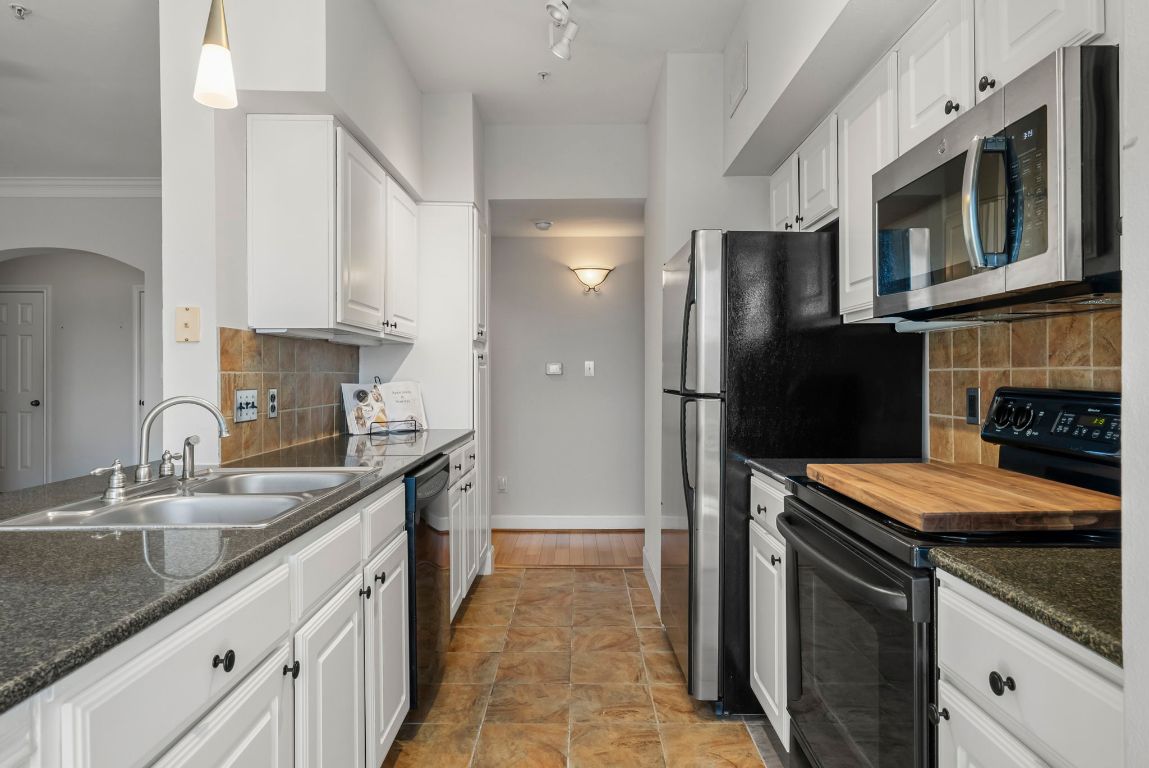 7701 Rialto Boulevard, Unit 1426 Austin, TX 78735 - Photo 3 of 29 a kitchen with stainless steel appliances granite countertop a refrigerator stove and sink