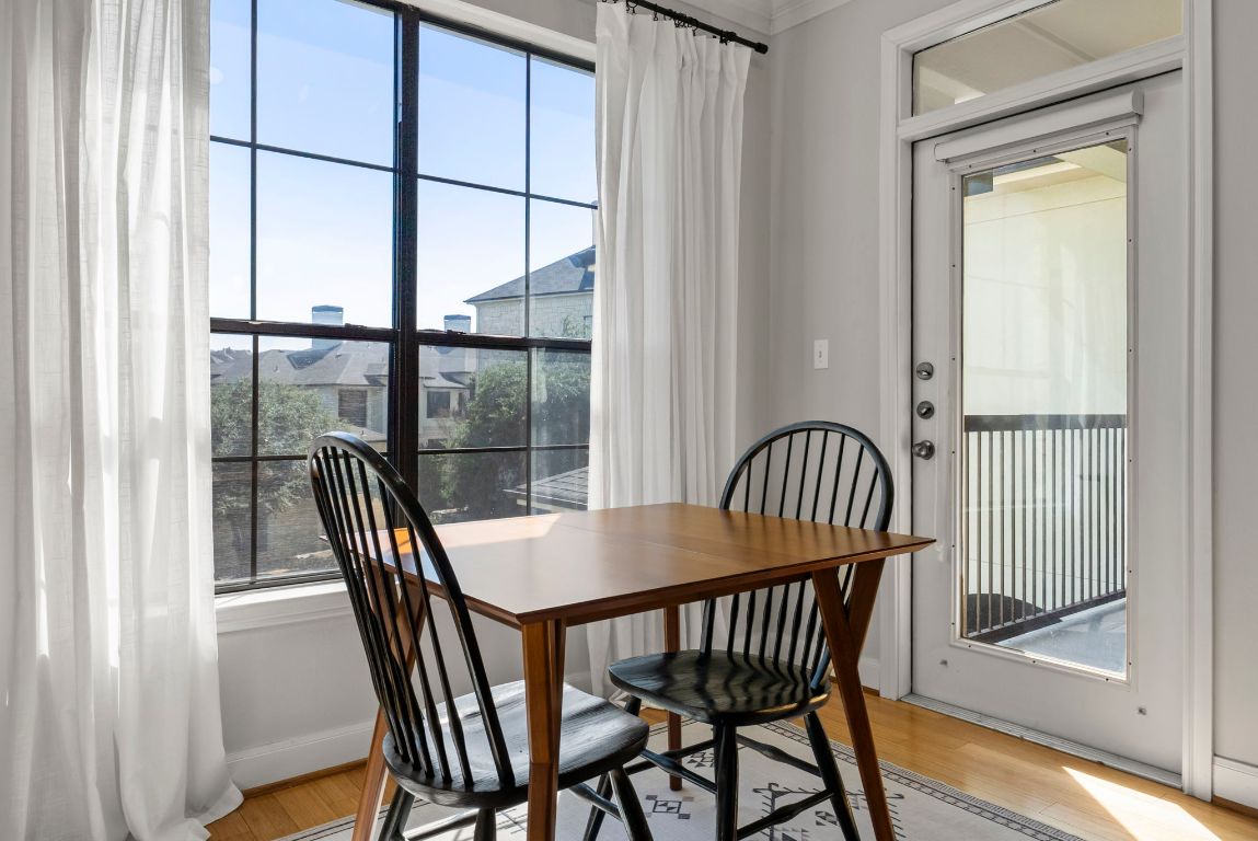 7701 Rialto Boulevard, Unit 1426 Austin, TX 78735 - Photo 5 of 29 a view of a dining room with furniture window and wooden floor