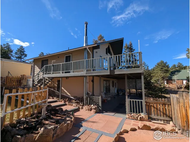 a front view of a house with a yard covered with snow