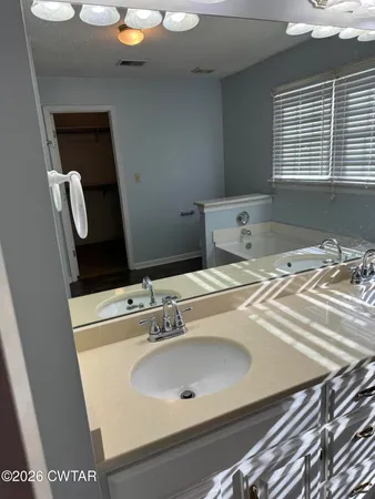 a bathroom with a bathtub and window