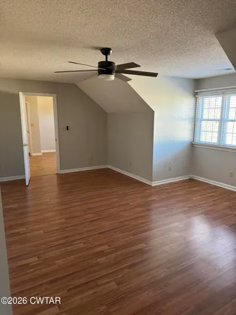a view of wooden floor and brick walls