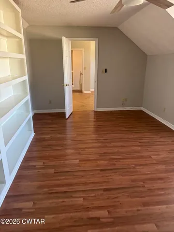 a view of staircase with railing and a rug