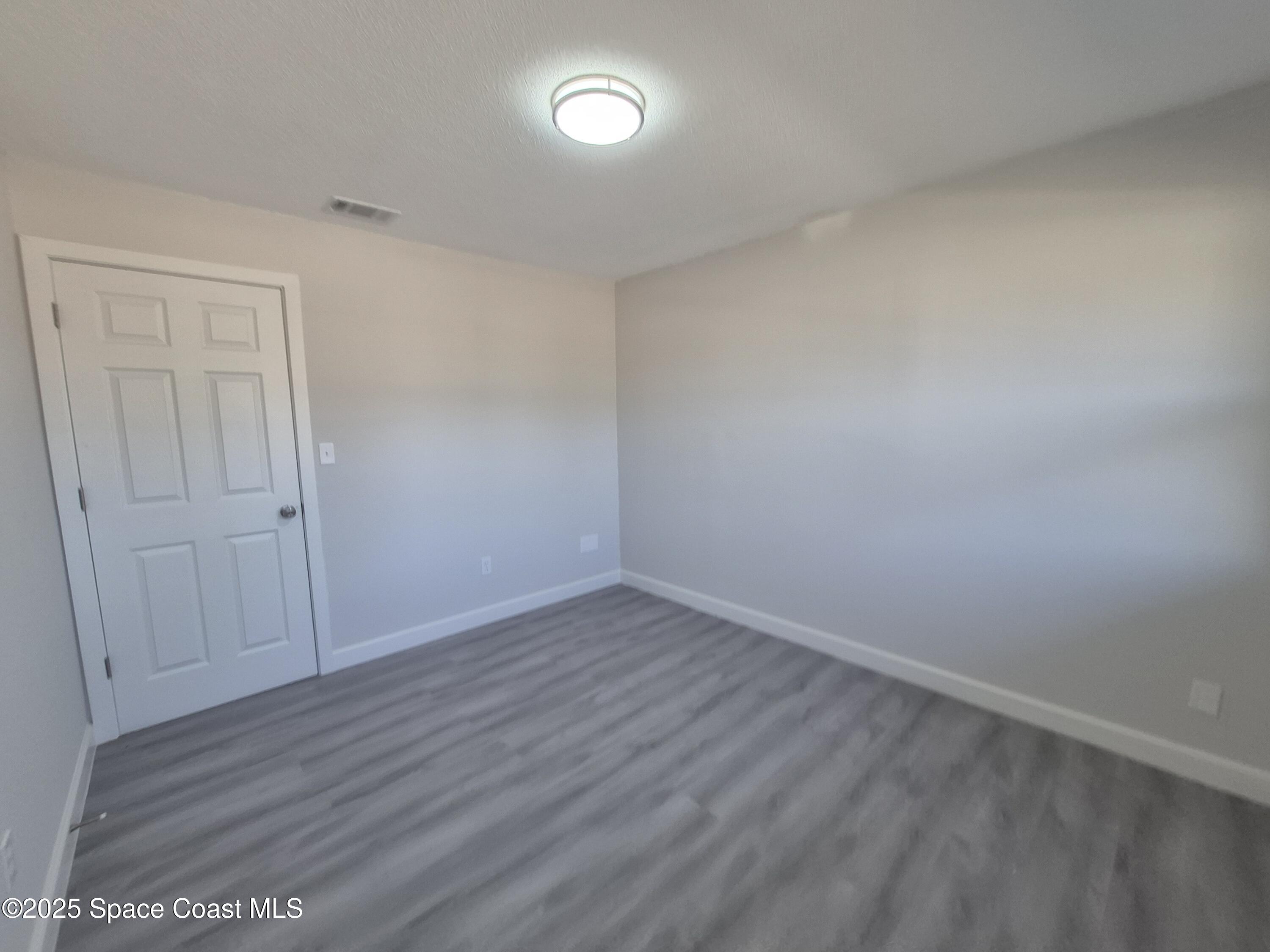 980 Bacon Circle Northeast Palm Bay, FL 32905 - Photo 33 of 50 wooden floor in an empty room