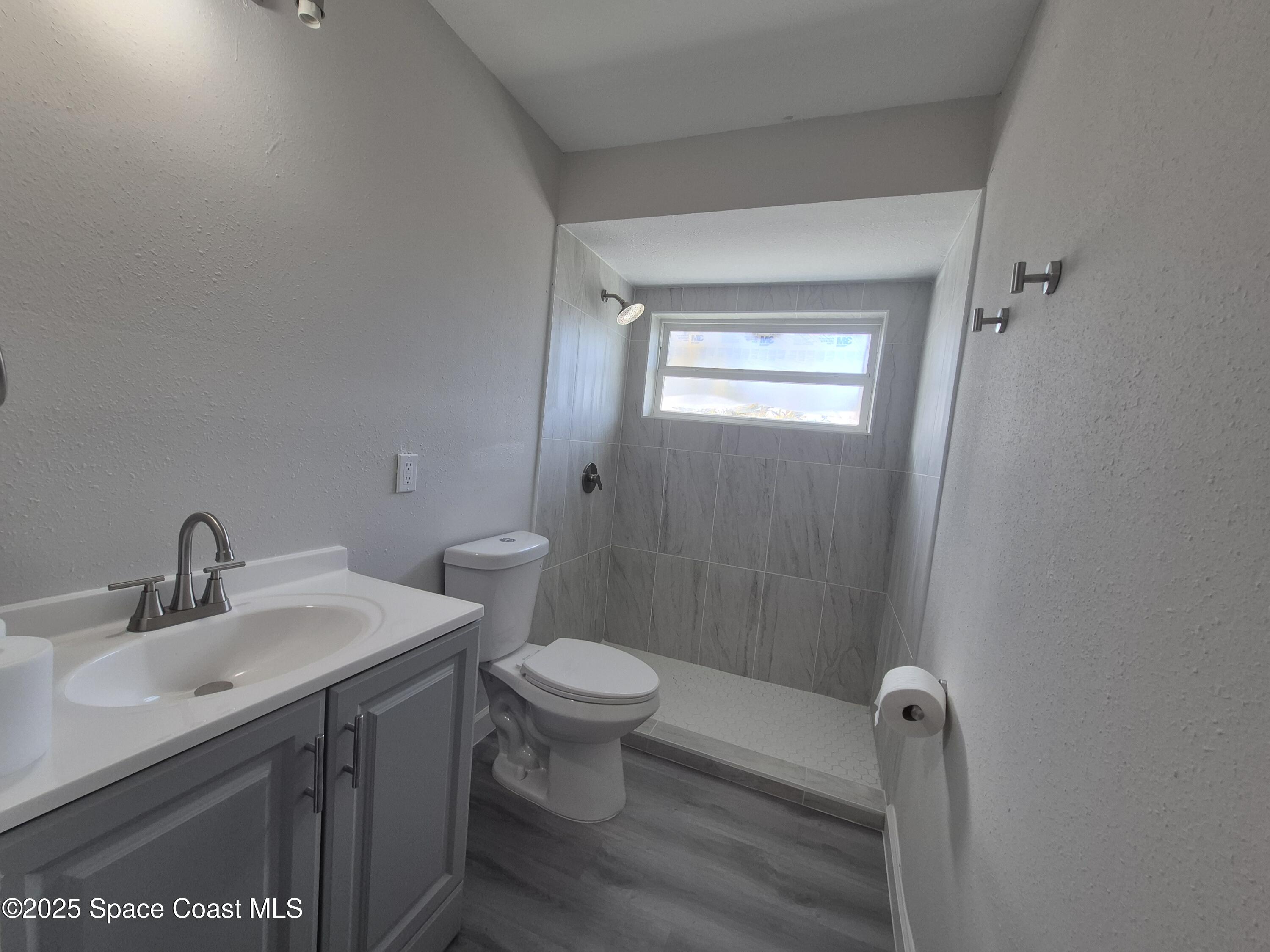 980 Bacon Circle Northeast Palm Bay, FL 32905 - Photo 34 of 50 a bathroom with a sink toilet and shower