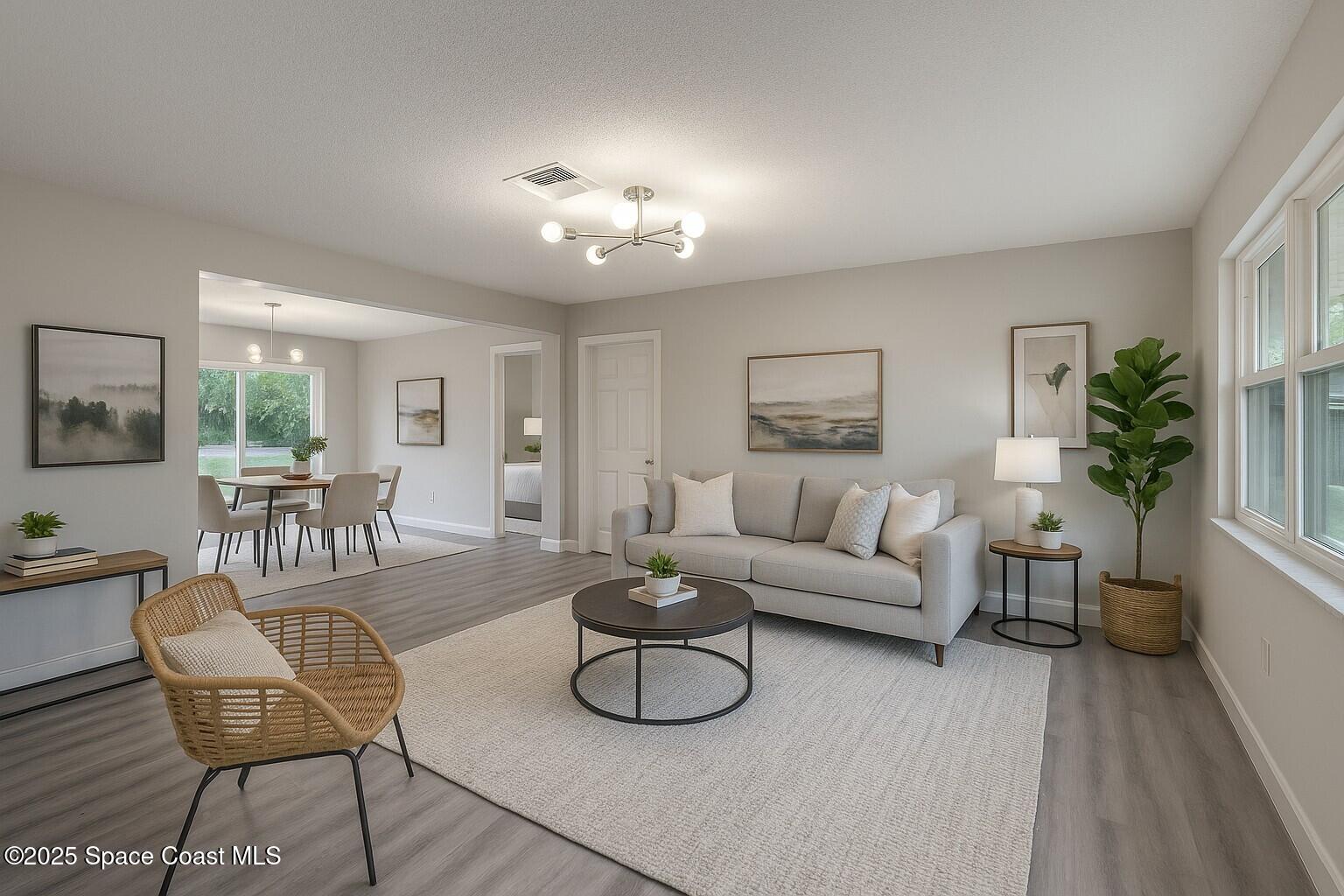 980 Bacon Circle Northeast Palm Bay, FL 32905 - Photo 9 of 50 a living room with furniture and a table