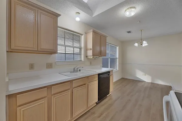 a kitchen with a sink cabinets and window
