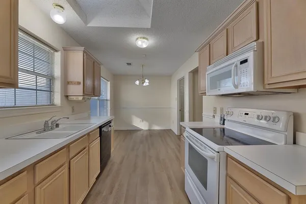 a kitchen with a sink stove and cabinets