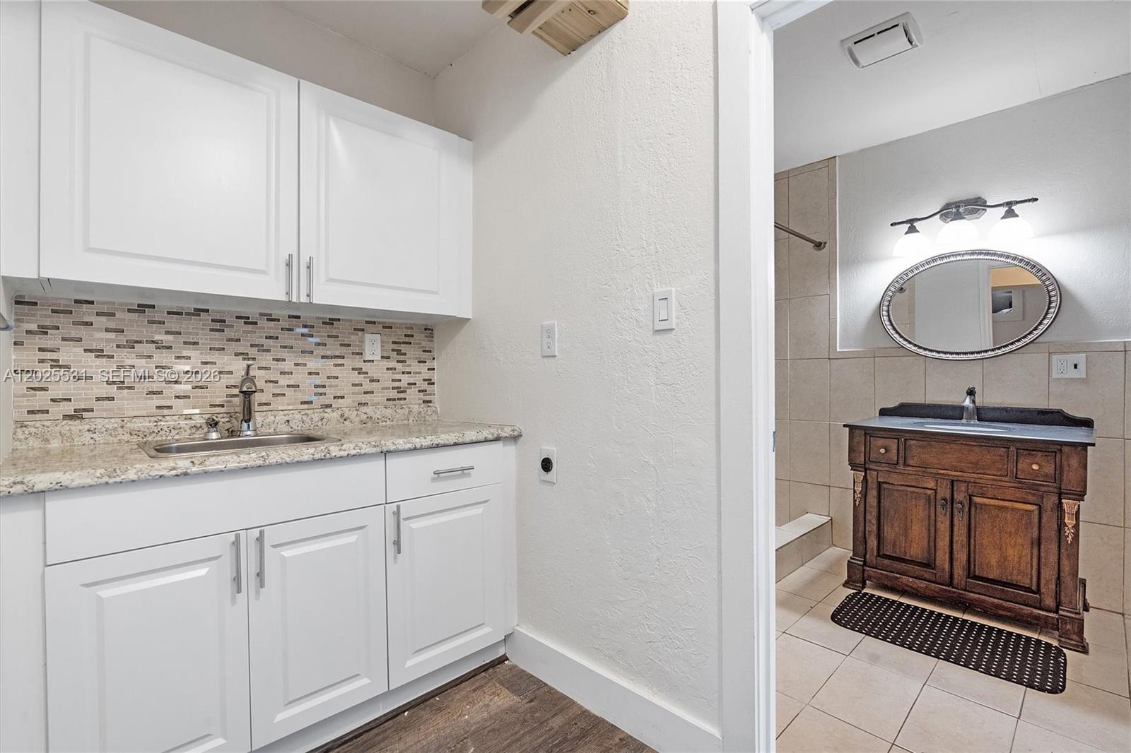 3951 Southwest 2nd Terrace, Unit 3951 Miami, FL 33134 - Photo 18 of 21 a bathroom with a sink and a mirror