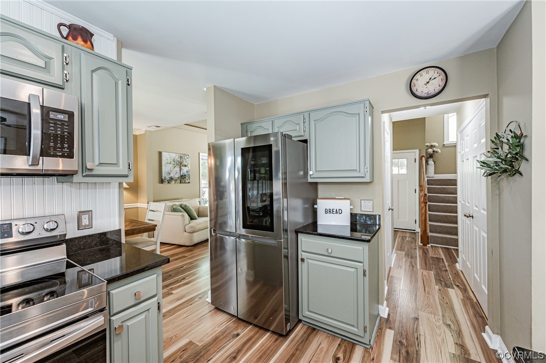 2908 Cove Ridge Trace Midlothian, VA 23112 - Photo 11 of 49 a kitchen with stainless steel appliances granite countertop a refrigerator and a stove top oven
