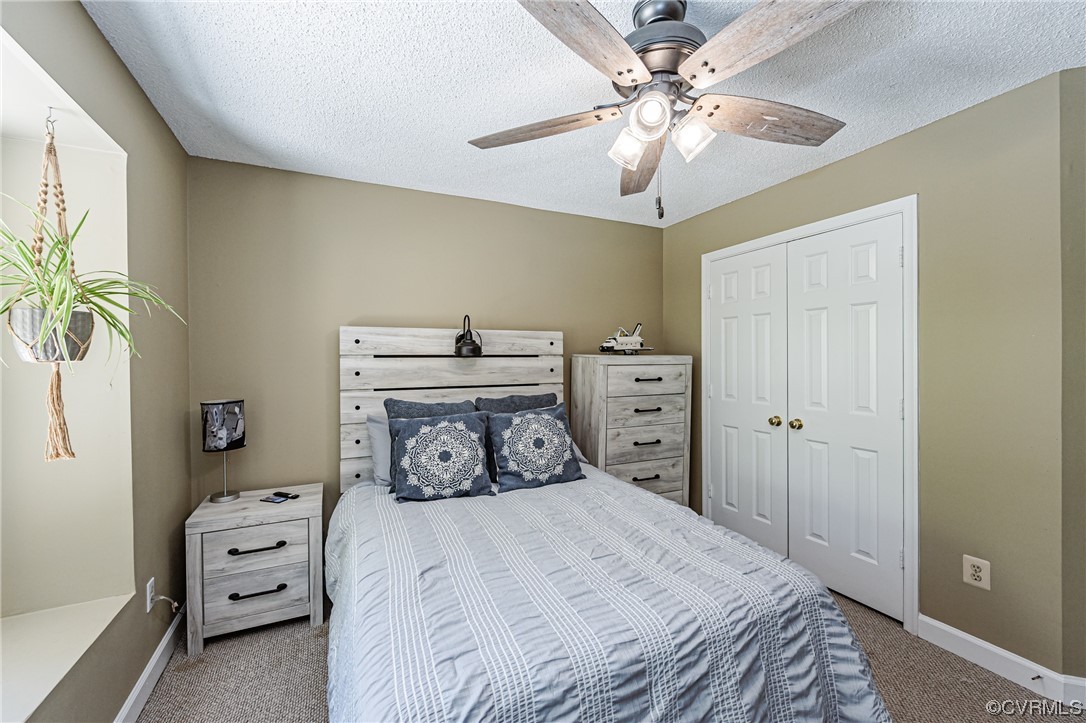 2908 Cove Ridge Trace Midlothian, VA 23112 - Photo 36 of 49 a bedroom with a bed and a chandelier