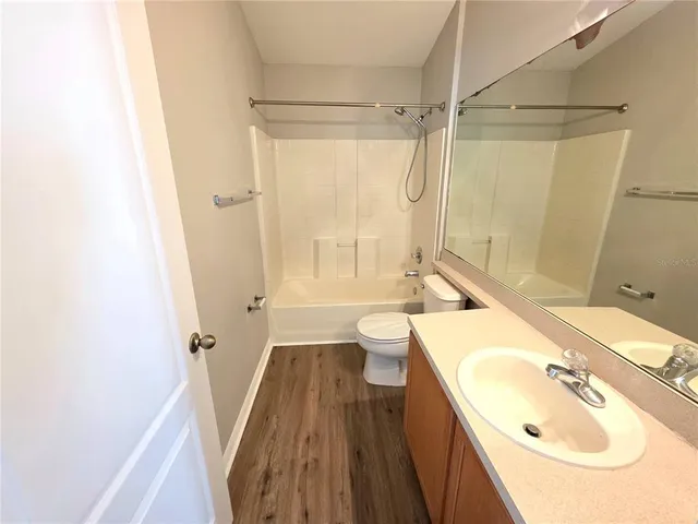a bathroom with a sink a toilet a tub and shower