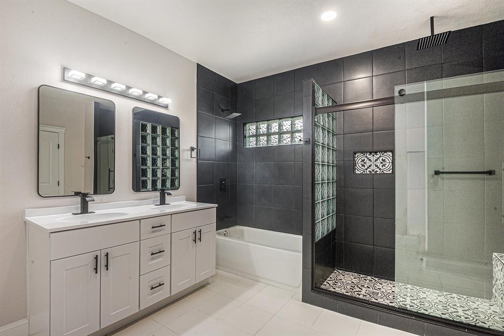290 Aurora Street Rhome, TX 76078 - Photo 6 of 11 a bathroom with a double vanity sink a large mirror and shower