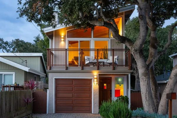 a view of a house with a backyard and balcony