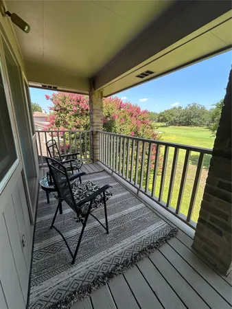 a view of a balcony with furniture