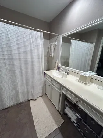 a bathroom with a double vanity sink and a mirror